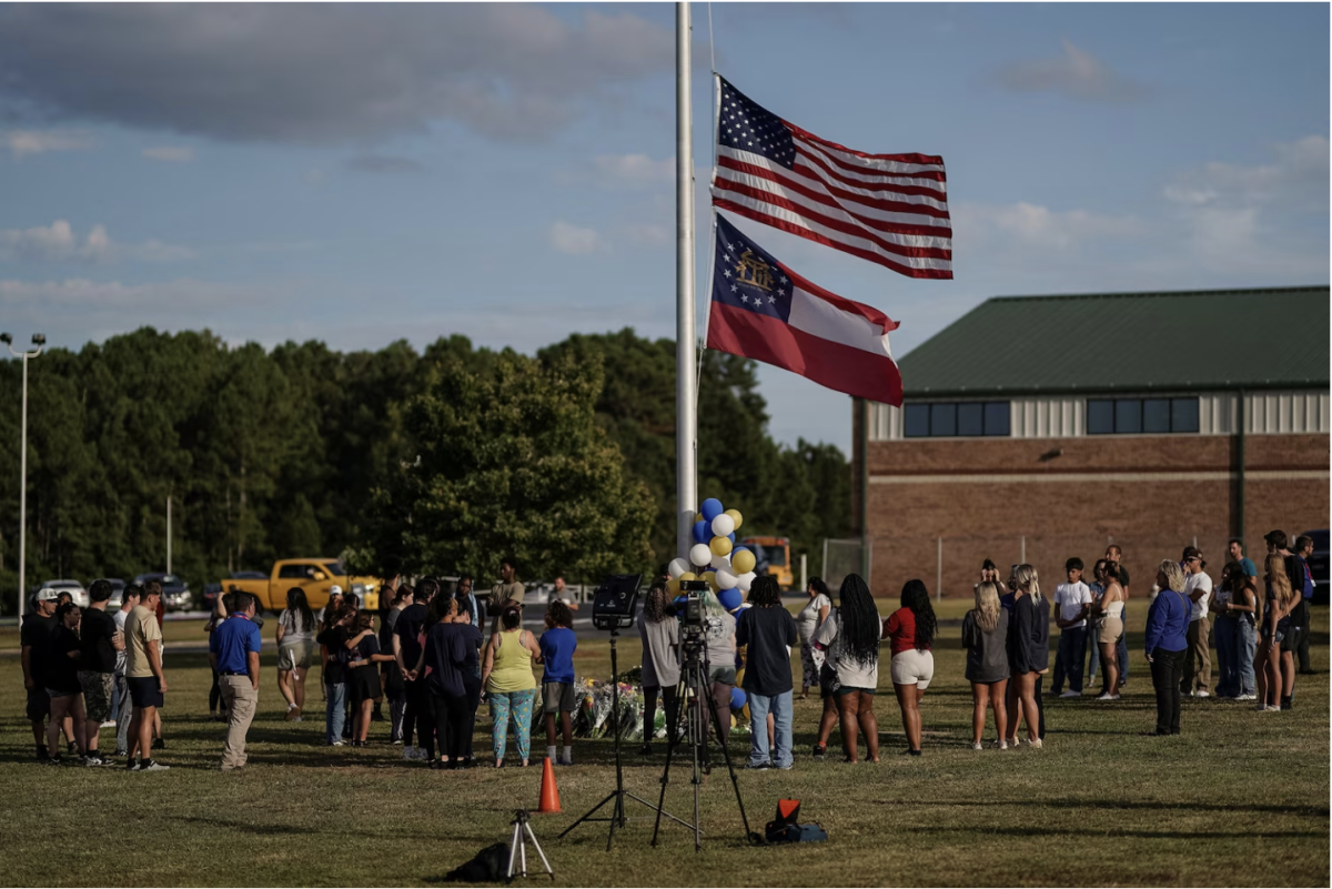 People pay their respects at the site of a makeshift memorial at Apalachee High School the day after a fatal shooting left four dead in Winder, Georgia, U.S. September 5, 2024.